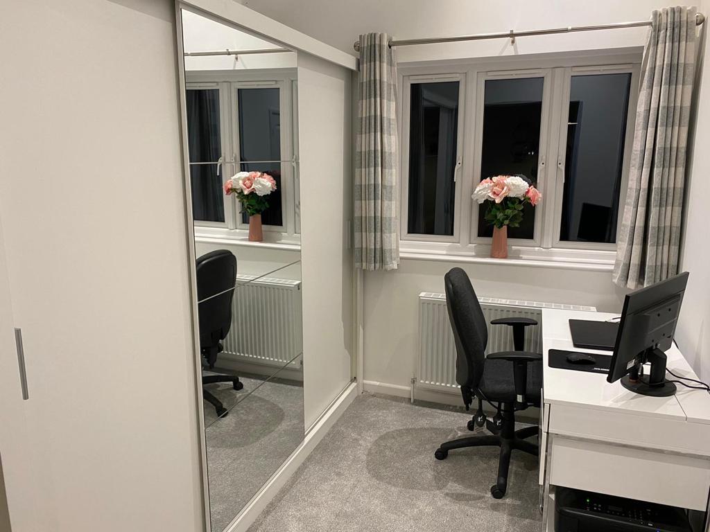 A small office spaced created in a walk-in dressing room