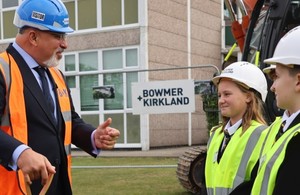 Builder talking to Coventry pupils outside their school
